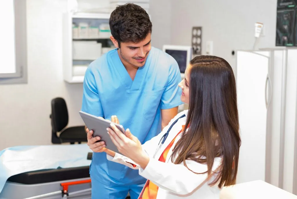 medics with tablet in office