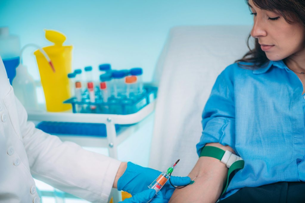 phlebotomy nurse taking blood for laboratory testing