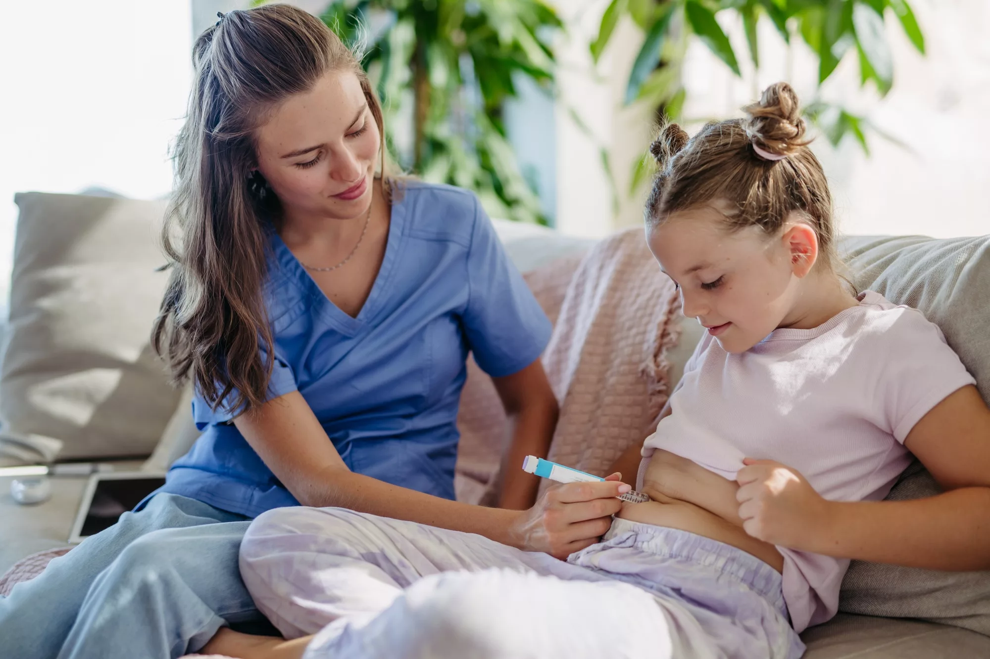 nurse injecting insulin in diabetic girl belly young girl with type 1 diabetes taking insuling with